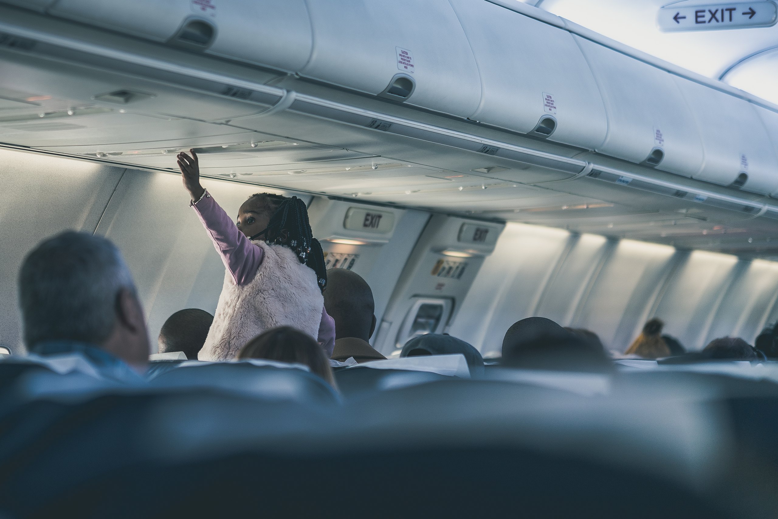 Child pressing the call button in an aircraft cabin